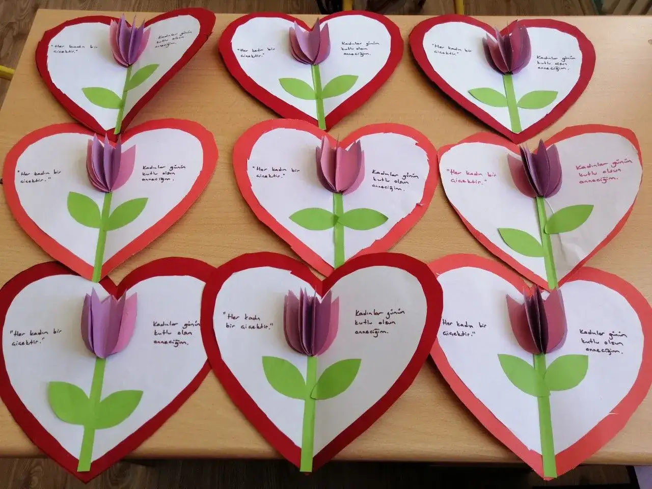 Manualidades de actividades día de la madre: corazones de papel con tulipas y mensajes.